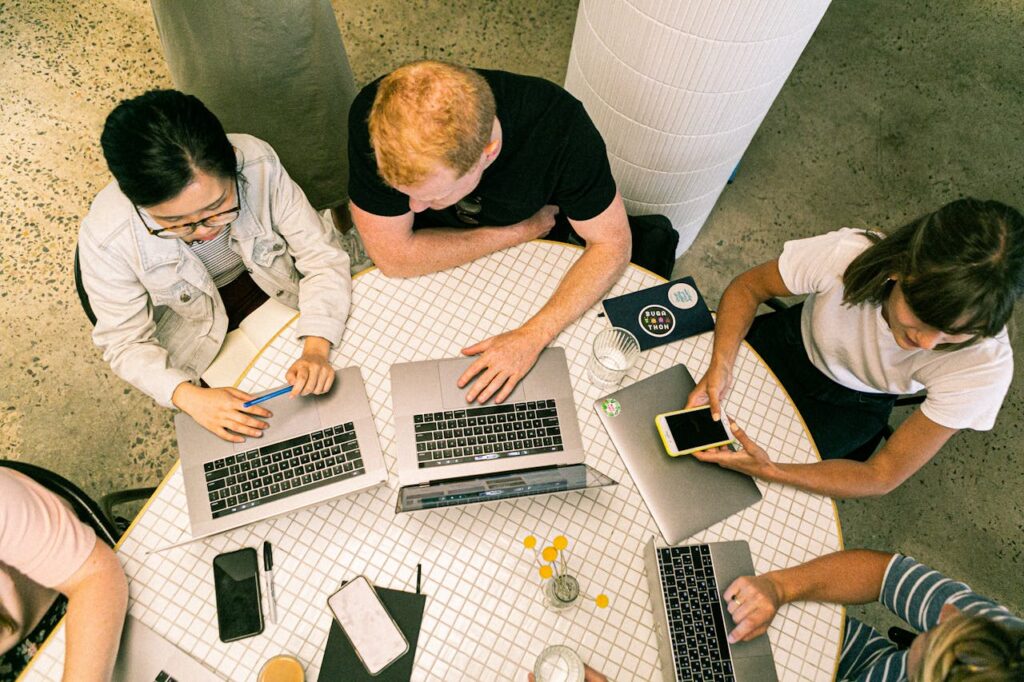 Photo of people using laptops to implement a marketing automation plan at their sustainability-focused company